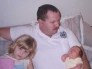 Officer Stafford and his two young daughters